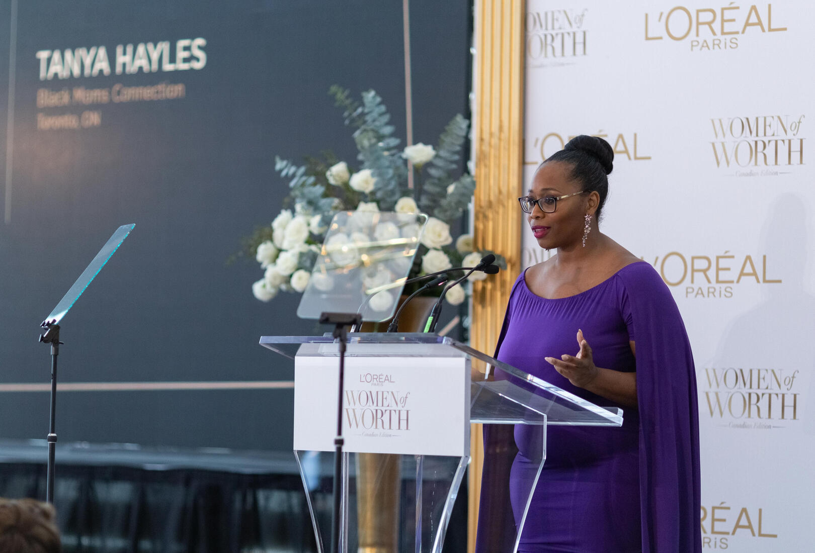 Tanya Hayles at podium accepting L'Oreal Paris Women of Worth award at 2020 gala